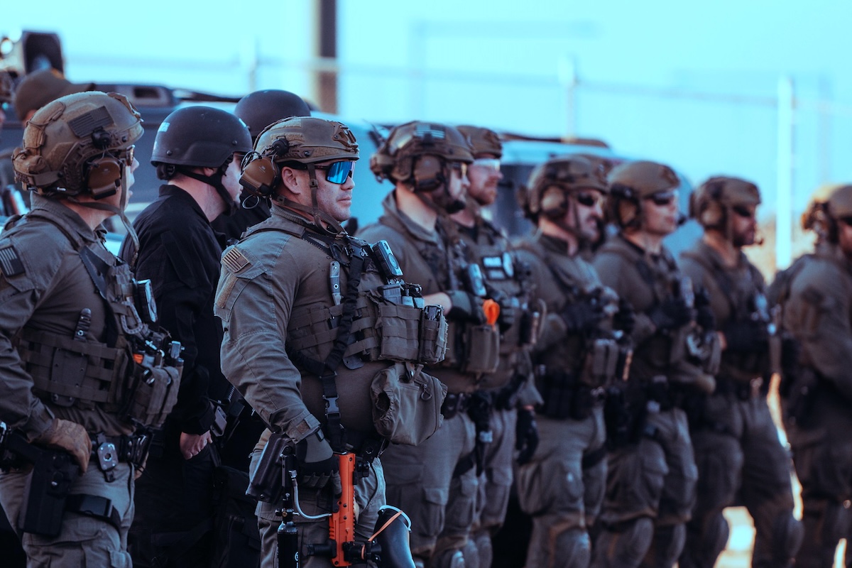 Armed soldiers standing in a row on a street