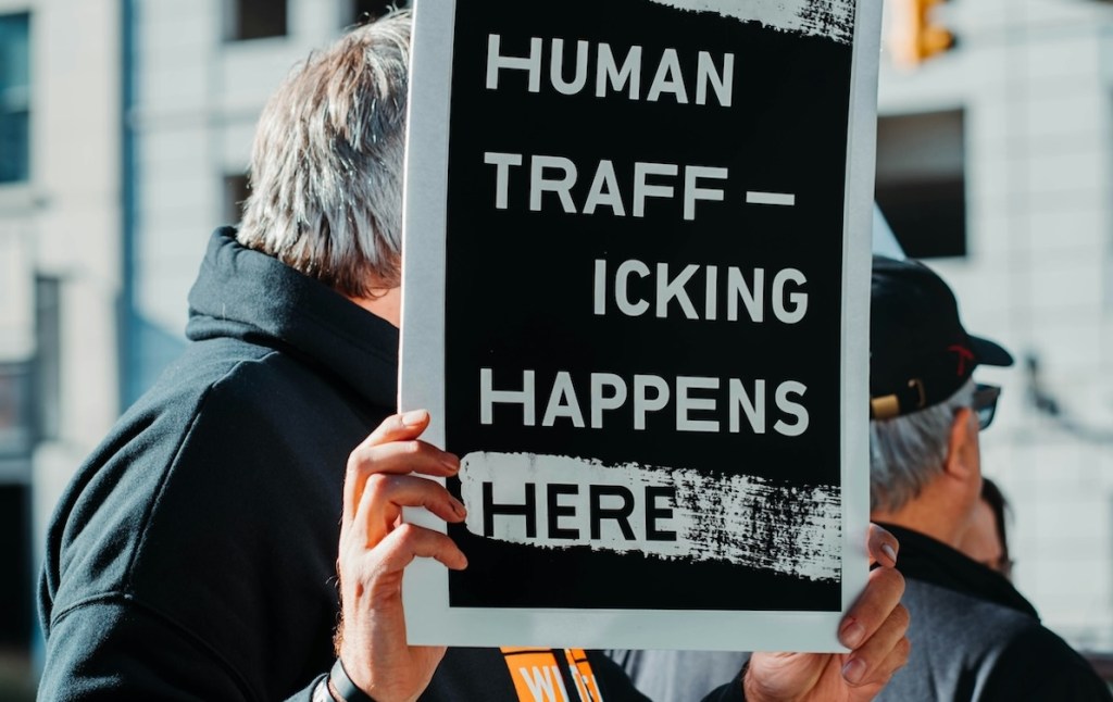 Person holding up a sign reading 